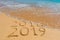 2018 2019 inscription written in the wet yellow beach sand being