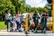 2018 DEC 22, New Zealand, Christchurch, People with green Lime Scooter are waiting for trafic light signal next to the garden