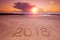 2018 inscription on wet beach sand