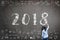 2018 new calendar year greeting by kid\\\'s hand drawing on school teacher\\\'s chalkboard with educational doodle