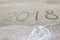 2018 written on the sand of a beach