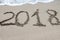 2018 written on the sand of a beach, closeup