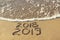2019, 2018 years written on sandy beach sea.