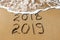 2019, 2018 years written on sandy beach sea. Wave washes awa