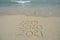  2019, 2020, 2021 handwritten on sandy beach shore