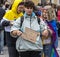 2019: A boy with a free kiss and free hugs sign attending the Gay Pride parade also known as Christopher Street Day CSD,Munich