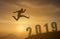 2019 brave man successful concept,silhouette man jumping over the sun between gap of the mountain to 2019 new year, feel like a wi