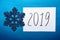 2019 Happy New Year card with text and glitter snowflake on blue background