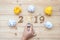2019 Happy New years with Businessman holding lightbulb with crumbled paper and wooden number on table. New Start, Idea, Creative,