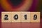 2019 on Wood cubes against colorful background