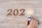 2020 Happy New year with Businessman holding lightbulb with crumbled paper and wooden number on table. New Start, Idea, Creative,