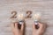 2020 Happy New year with Businessman holding lightbulb with crumbled paper and wooden number on table. New Start, Idea, Creative,