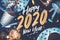 2020 happy new year hand brush storke font on marble table with party cup,party blower,tinsel,confetti.Fun Celebrate holiday party