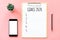 2020 New year concept. Goals list in stationery, blank clipboard, smartphone, pot plant on pink pastel color with copy space