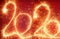 2020 new year sparkling numbers on red background