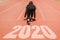 2020 Newyear , Athlete Woman starting on line for start running with number 2020 Start to new year