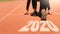 2020 Newyear , Athlete Woman starting on line for start running with number 2020 Start to new year