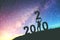 2020 Newyear Man tries to Lift up number of 2020 Happy new year background on  the Milky Way galaxy