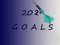 2020 plan concept. New year goals with a green color dart on blurred blue background. Free space for text.