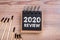 2020 Review. Burnt matches and notebook on a wooden table