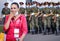 2020 Russia Alabino. the girl took off her medical mask and laughs, at this time from behind Soldiers in medical masks march at