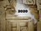 2020 year concept - 2020 number on wood broken surface in vintage background