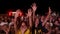 2021-08-06 - Mariupol City Festival, Ukraine. Energetic crowd dances at night music festival with hands up. Friends