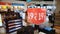 2021.08.18 Benidorm, Spain a lighted market with display cases, shelves, lots of goods and a man with a cap looking at