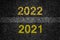 2021, 2022 on asphalt road surface with markings. The concept of the coming New Year, new plans, and ideas.