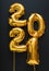 2021 balloon gold text on black background. Happy New year eve invitation with Christmas gold foil balloons 2021. Vertical