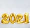 2021 balloon text on white background. Happy New year eve invitation with Christmas gold foil balloons 2021. Square flat lay with