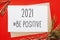 2021 be positive christmas note with fir branch on red isolated background. New Year concept