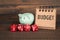 2021 BUDGET. Family, health and politics concept. Red dice, piggy bank and notebook