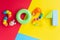 2021 Christmas kids. Numbers from rainbow construction blocks and toys on a bright colorful background. Children\\\'s colorful