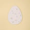 2021 Easter egg shape with white pearls on beige background. Minimal holiday concept.