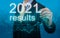 2021 economic results review. businessman writes 2021 results on virtual screen. economic indicators, overcoming the crisis and