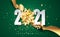 2021 green Happy New Year vector background with golden gift ribbon, confetti, white numbers. Christmas celebrate design