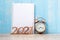 2021 Happy New Year  with blank notebook, retro alarm clock and wooden number. New Start, Resolution, Goals, Plan, Action and