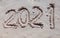 2021 inscription on the sand of the beach. Summer beach holidays in 2021. The message is handwritten