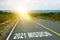 2021 mission inscription on straight road. Sunny morning landscape. Motivational inscription on the road going forward. The