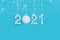 2021 New Years numbers made of white artificial snow on blue background