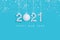 2021 New Years numbers made of white artificial snow on blue background