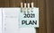 2021 Plan notes paper and a clothes pegs on wooden background