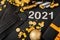 2021 text lettering with black medical face masks, gold Christmas festive decor. Protective face surgical masks in Celebrating New