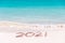 2021 written on the sand of a beach travel 2020 new year concept