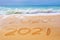 2021 written on the sand of a beach travel 2021 new year concept and greeting card