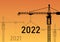 The 2021 Year forward to 2022 Year Happy new Year construction site crane vector illustration on sunset background. The concept