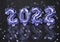 2022 balloons on violet dark background with glitters.