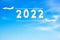 2022 in Cloud Sky New Year Concept. Two Airplane Drawing 2022 with clouds ageist Smooth Turquoise Sky. Happy new year creative