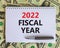 2022 fiscal new year symbol. White note with words 2022 fiscal year on beautiful white background, dollar bills, metallic pen.